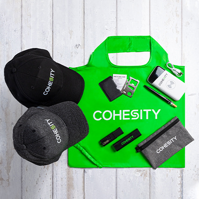 Cohesity branded caps, tote bag, pouch and tech accessories kit