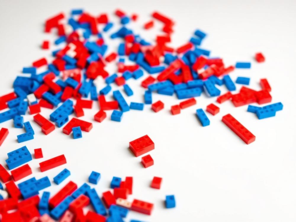 Teal and pink interlocking bricks laid out as a prototype build in progress